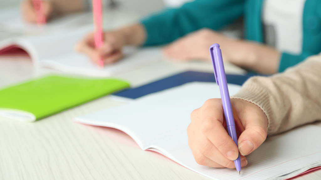 A picture of an elementary student using basic skills of writing.